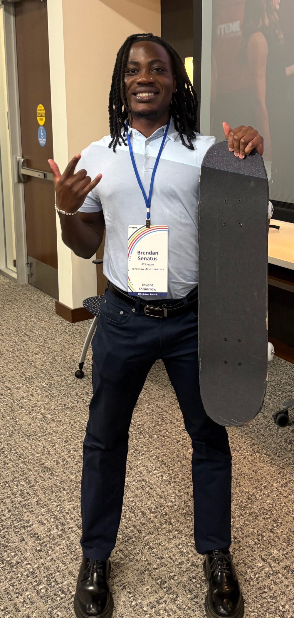 Brendan Senatus at Centene's 2026 Intern Summit holding a skateboard his team built